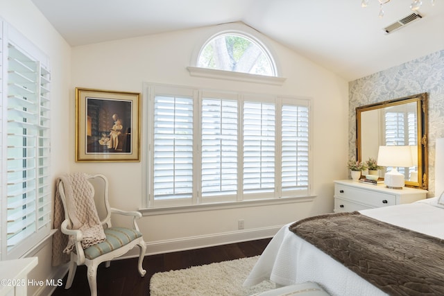 bedroom featuring dark wood-style flooring, vaulted ceiling, and baseboards