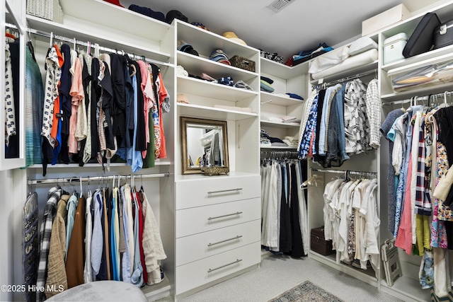 walk in closet featuring carpet