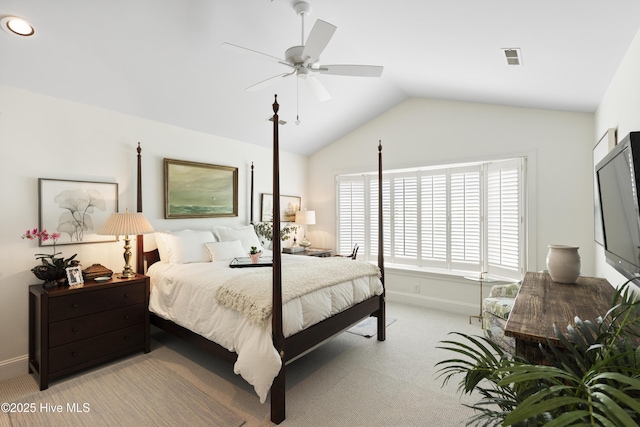 bedroom with light carpet, vaulted ceiling, baseboards, and ceiling fan