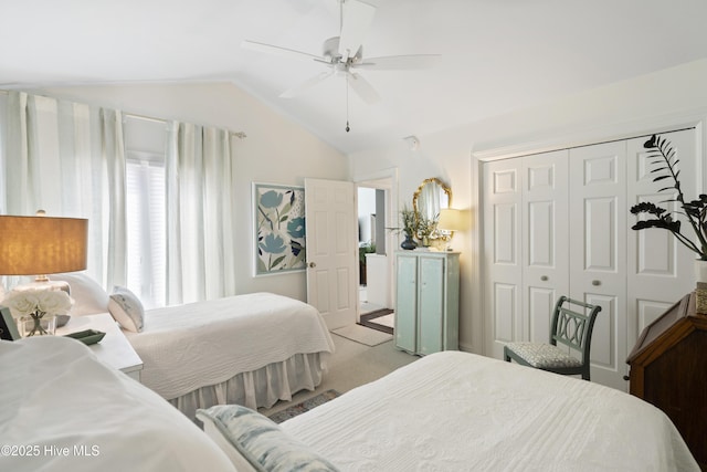 bedroom featuring vaulted ceiling, a closet, a ceiling fan, and light carpet