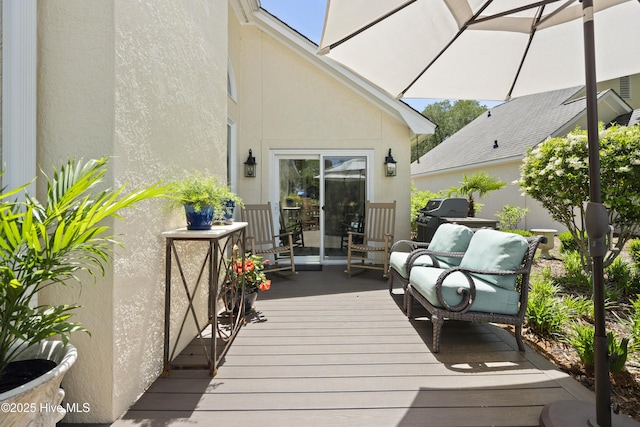 wooden deck featuring a grill
