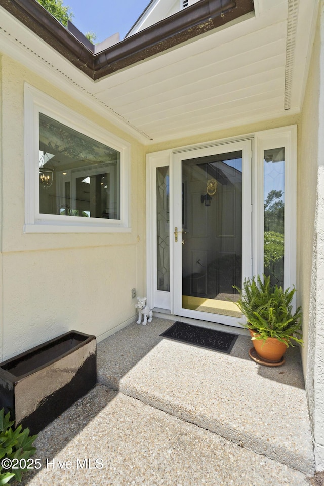 entrance to property featuring stucco siding