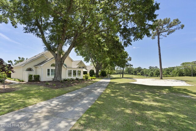 view of front of home featuring a front lawn and stucco siding