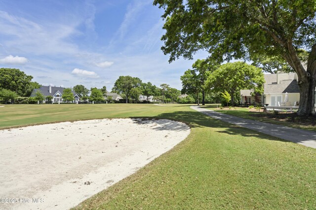 view of home's community featuring a lawn and a residential view