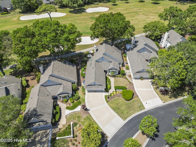 aerial view of residential area featuring a golf course