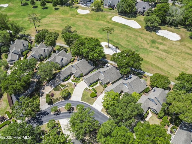 aerial overview of property's location featuring nearby suburban area and a golf course