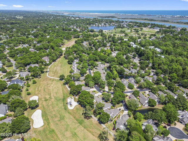 aerial view of property's location with a large body of water, nearby suburban area, and a golf course