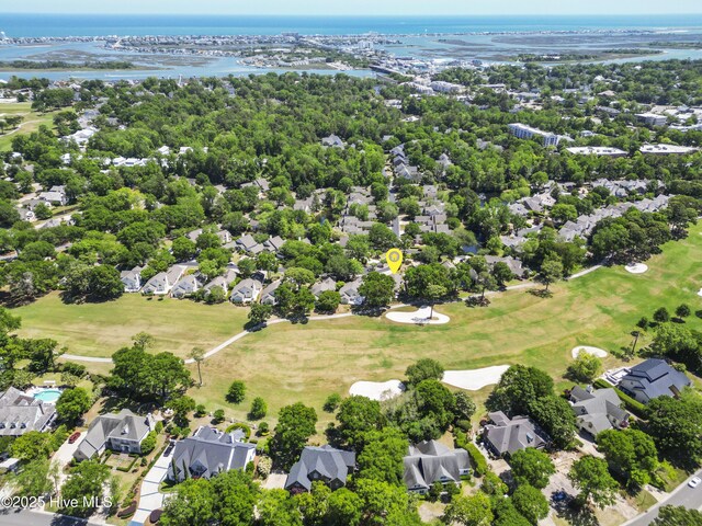 aerial view of property's location with a large body of water, nearby suburban area, and a local golf course