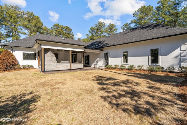 rear view of house with a yard