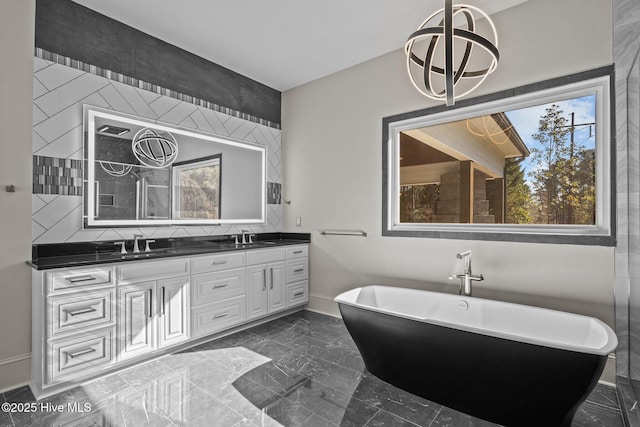 bathroom with tasteful backsplash, vanity, and a bath