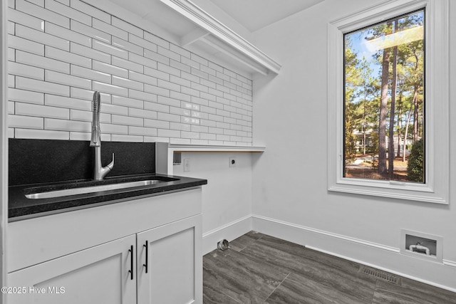 clothes washing area featuring cabinets, hookup for a washing machine, sink, and hookup for an electric dryer