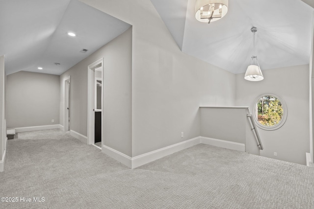 interior space featuring vaulted ceiling and light colored carpet