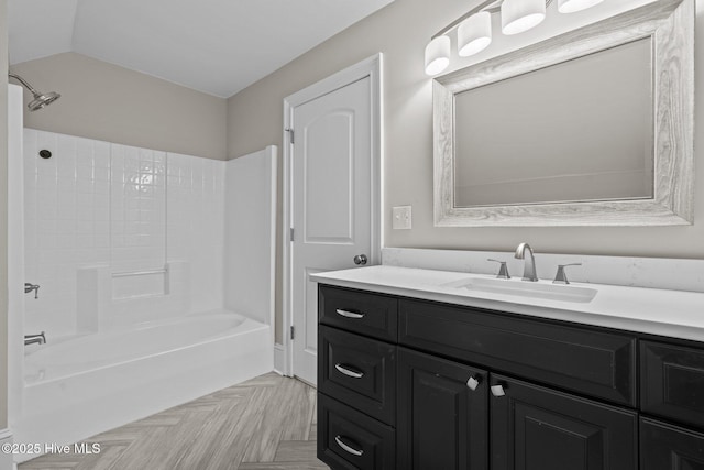 bathroom featuring vanity, parquet flooring, and shower / bath combination