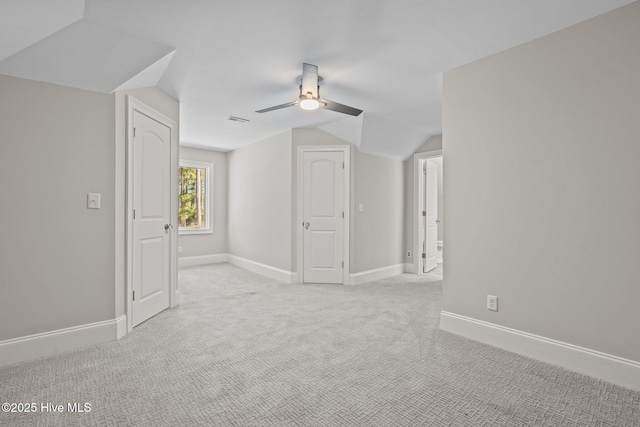 bonus room with vaulted ceiling, light carpet, and ceiling fan