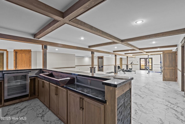 kitchen with coffered ceiling, beverage cooler, beam ceiling, and kitchen peninsula