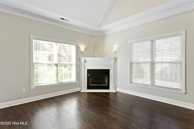 unfurnished living room with dark wood-type flooring, a fireplace, vaulted ceiling, and crown molding