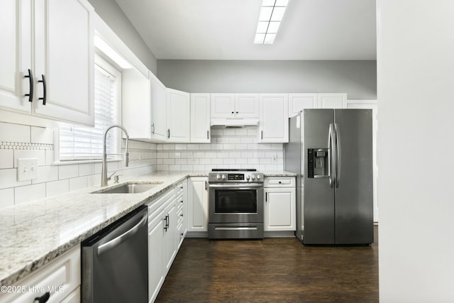 kitchen featuring tasteful backsplash, sink, white cabinets, stainless steel appliances, and light stone countertops