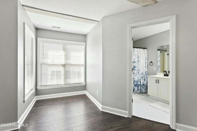 interior space with dark hardwood / wood-style flooring and sink