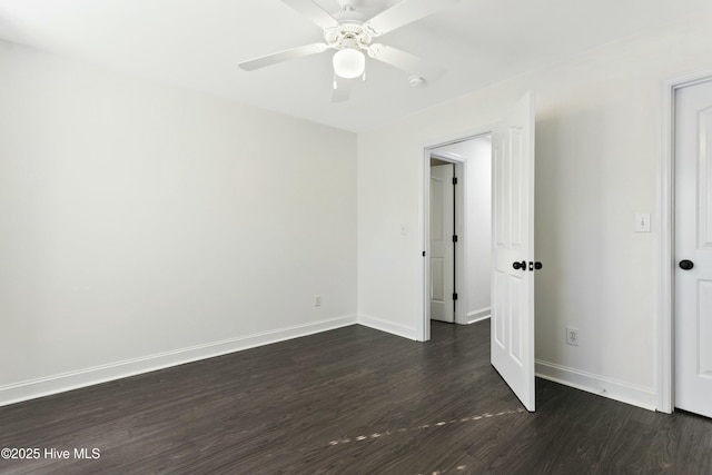 spare room featuring dark wood-type flooring and ceiling fan