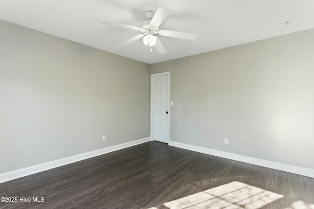 unfurnished room featuring dark wood-type flooring and ceiling fan