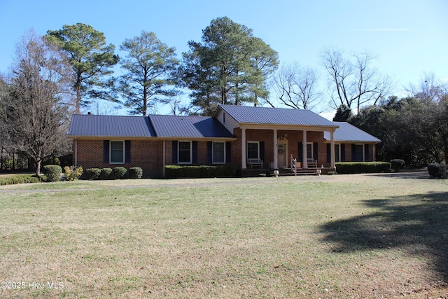 ranch-style home with covered porch and a front yard