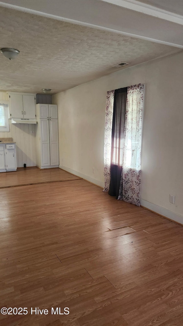 interior space featuring baseboards and wood finished floors