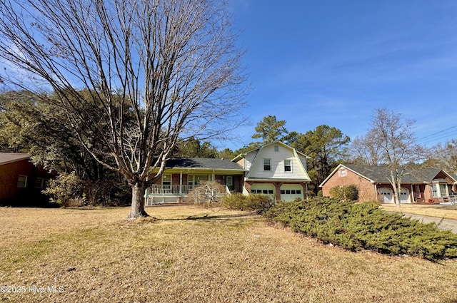 split level home with a garage, covered porch, and a front yard