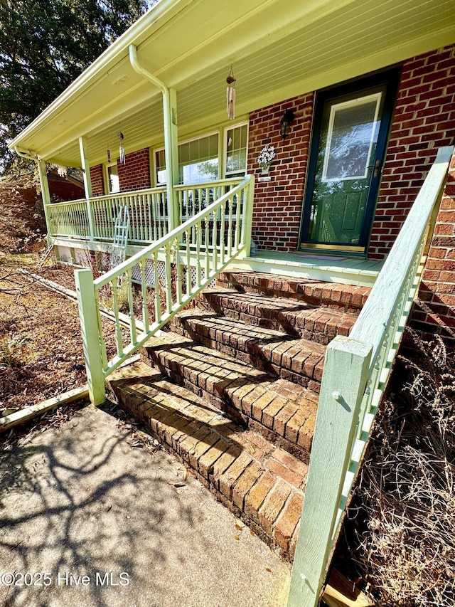 property entrance with covered porch