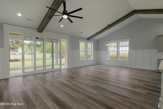 unfurnished living room featuring lofted ceiling with beams, dark hardwood / wood-style flooring, and ceiling fan with notable chandelier