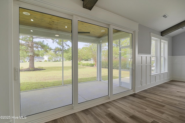 entryway with hardwood / wood-style flooring and beam ceiling