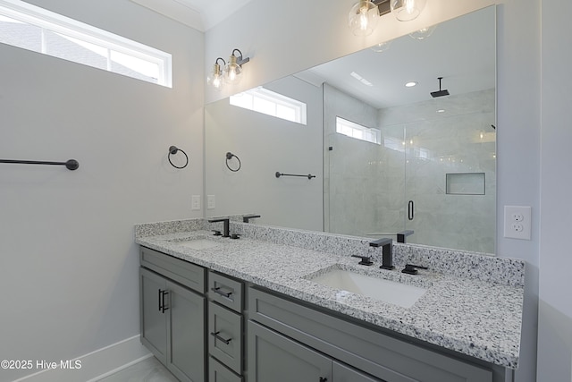 bathroom featuring a healthy amount of sunlight, a shower with door, and vanity