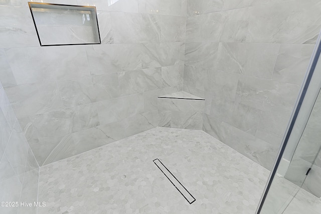 bathroom with a tile shower