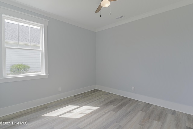 spare room featuring crown molding, ceiling fan, and light wood-type flooring