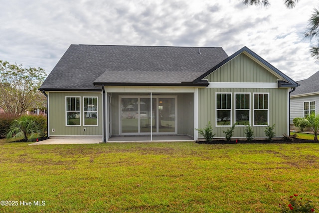 rear view of house featuring a lawn and a patio area