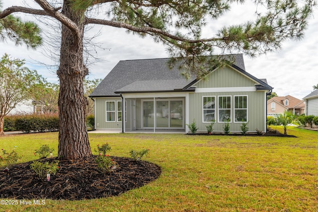 rear view of house with a lawn and a patio