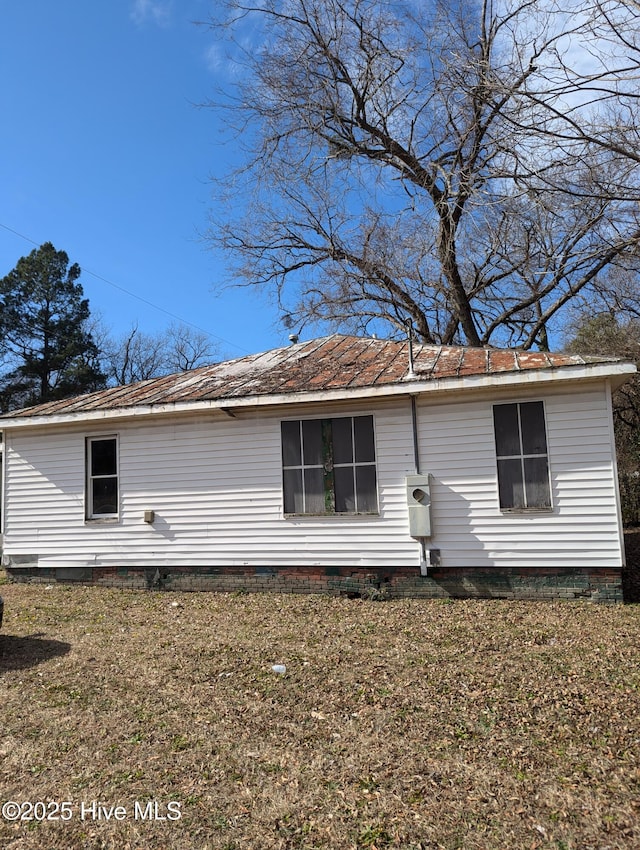 view of side of property with a yard