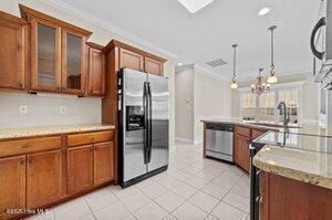 kitchen with appliances with stainless steel finishes, light countertops, and brown cabinetry