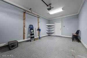 garage featuring baseboards and a garage door opener