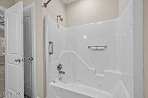 bathroom with shower / washtub combination