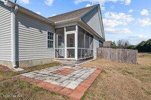 rear view of house with a patio area, fence, and a sunroom