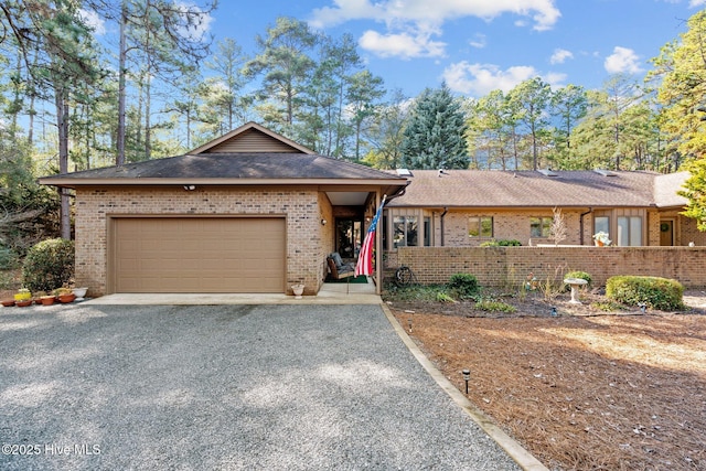 370 Fairway Ct, Pinehurst, NC 28374 - ranch-style home featuring brick siding, fence, gravel driveway, an attached garage, and a shingled roof