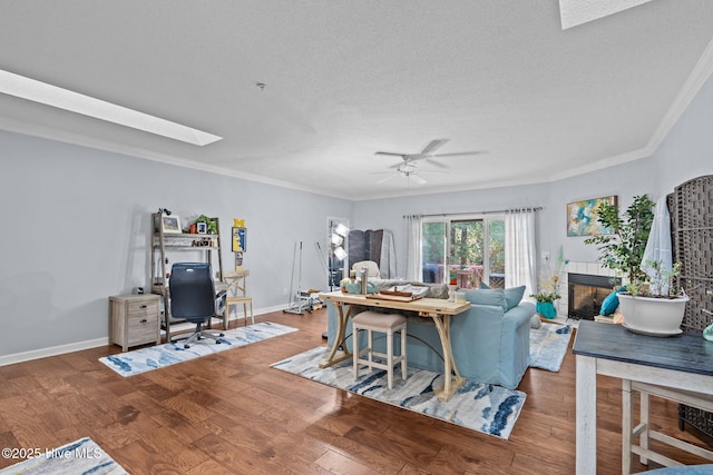 370 Fairway Ct, Pinehurst, NC 28374 - living room with ornamental molding, a desk, a textured ceiling, wood finished floors, and a skylight