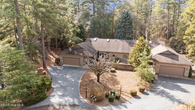 370 Fairway Ct, Pinehurst, NC 28374 - view of front of property with a garage, roof with shingles, driveway, and brick siding