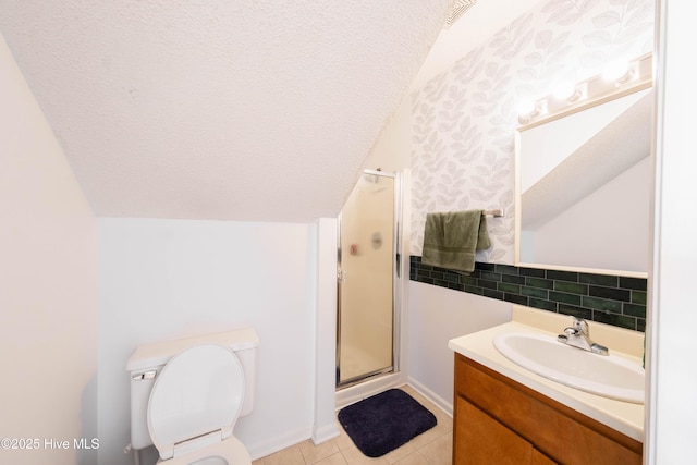 bathroom featuring a shower with door, vanity, vaulted ceiling, and a textured ceiling