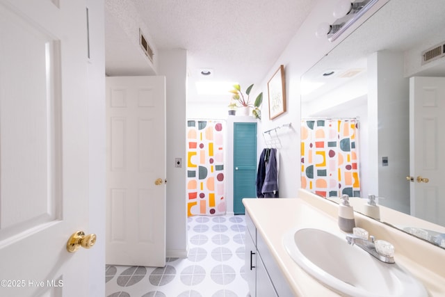 bathroom with vanity and a textured ceiling