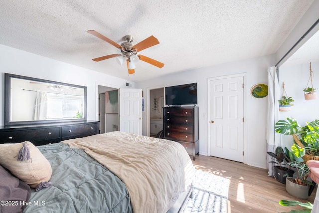 bedroom with ceiling fan, a textured ceiling, and light wood-type flooring