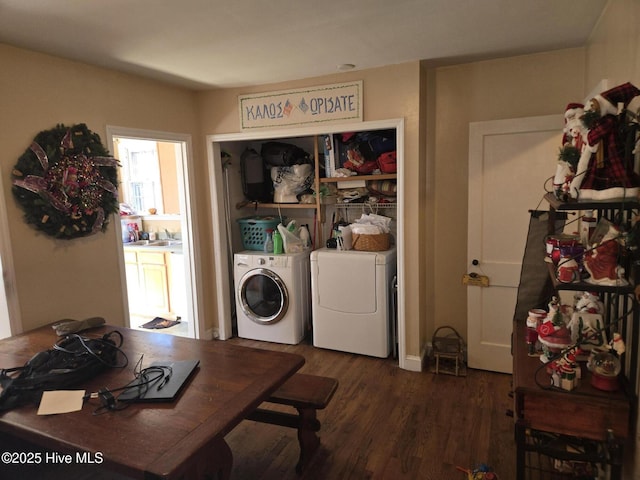 laundry room with washer and dryer, sink, and dark hardwood / wood-style flooring