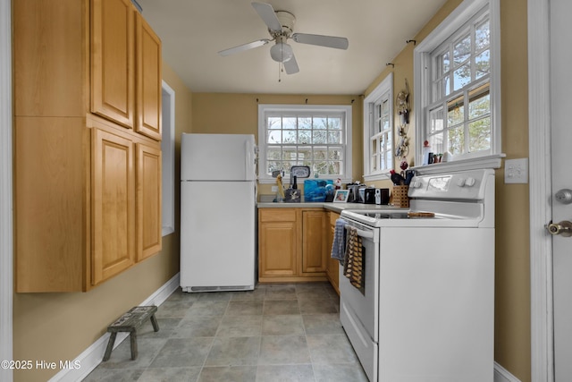 kitchen featuring ceiling fan, a wealth of natural light, light brown cabinetry, and white appliances