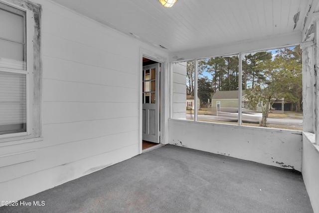 unfurnished sunroom with wood ceiling