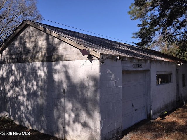 view of side of home featuring a garage